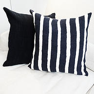 Striped cushion on a white sofa. Modern furniture.